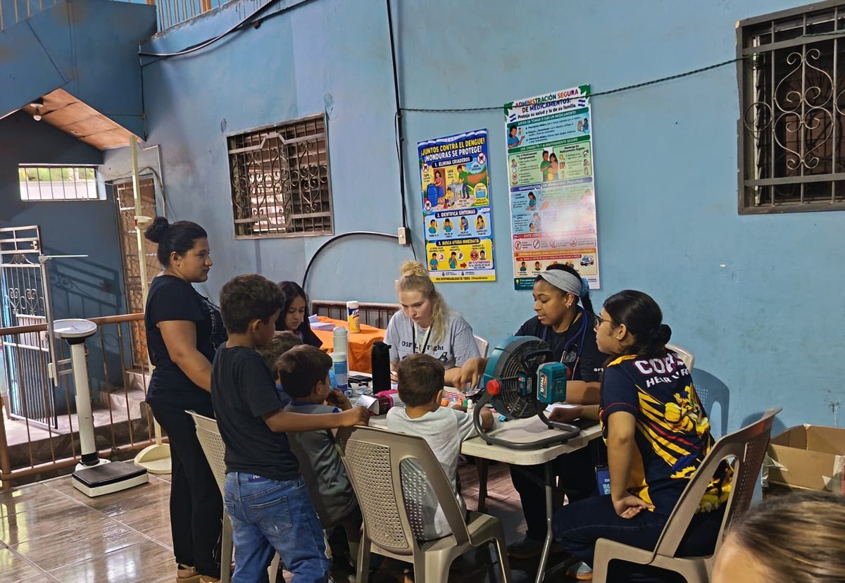 A student translates for a family during a consultation