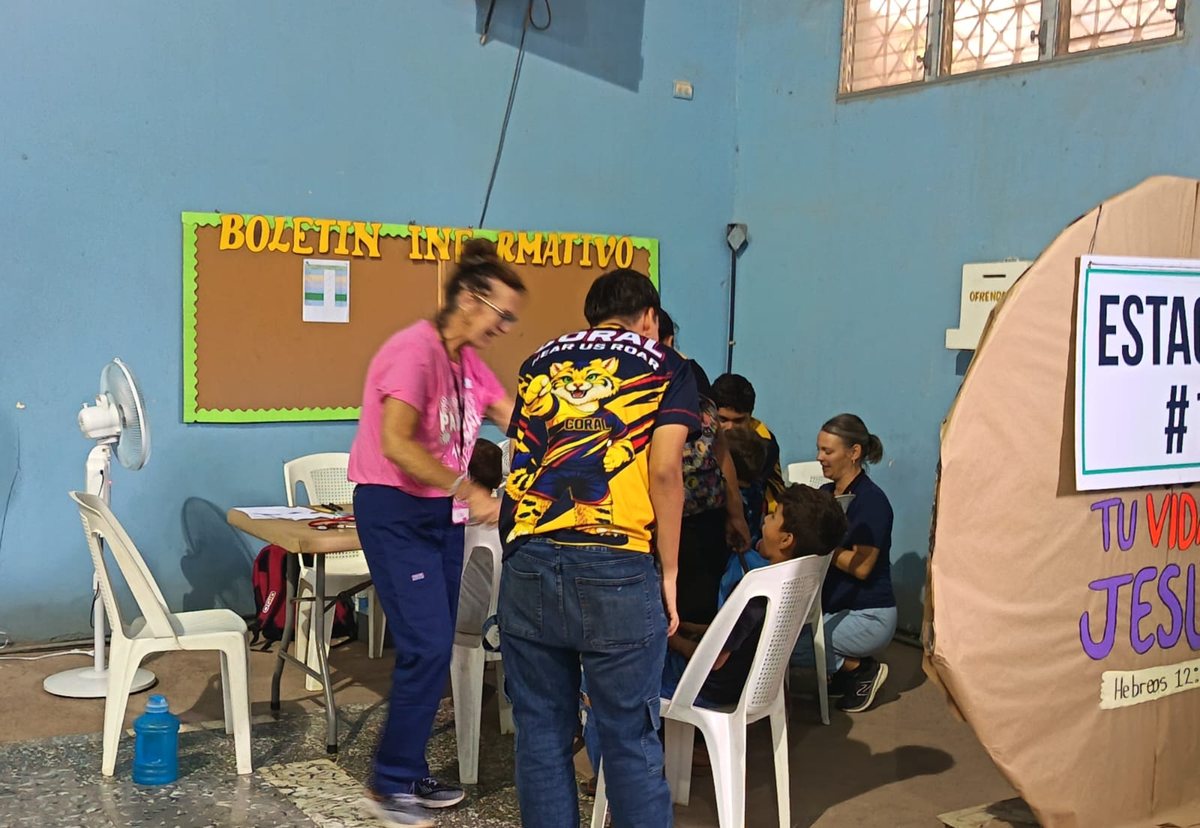 A student working alongside a nurse